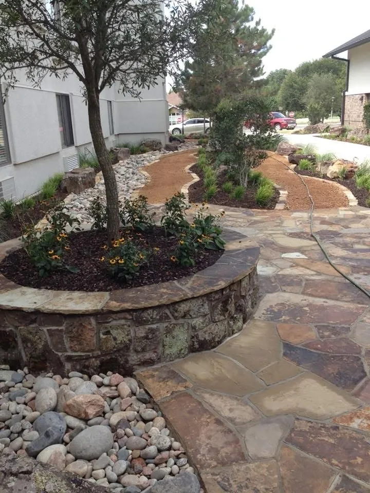 Stone path and planted beds on a wooded Copper Canyon, TX property