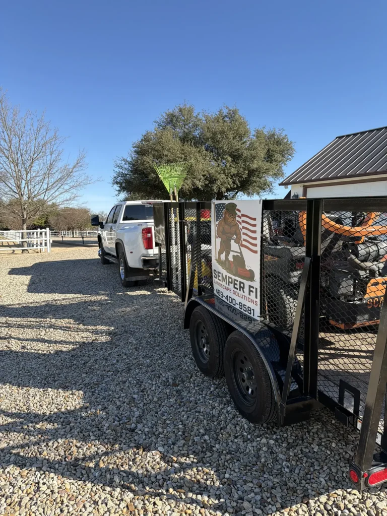 Semper Fi Landscape Solutions truck and trailer on a job site in Double Oak, TX