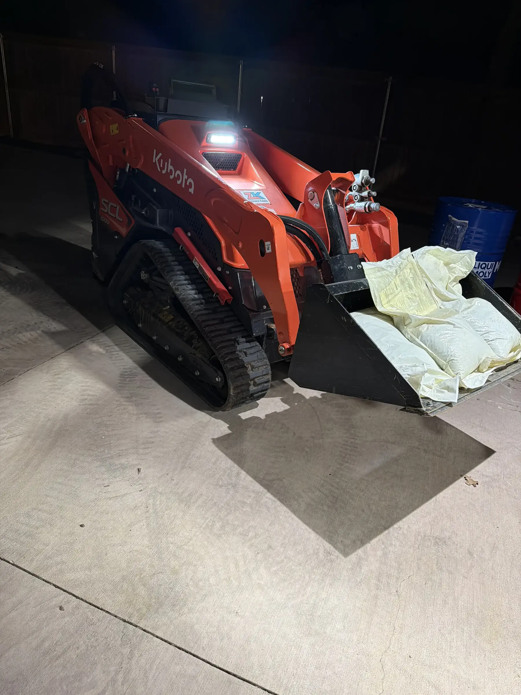 Semper Fi Landscape Solutions skid steer grading acreage in Bartonville, TX