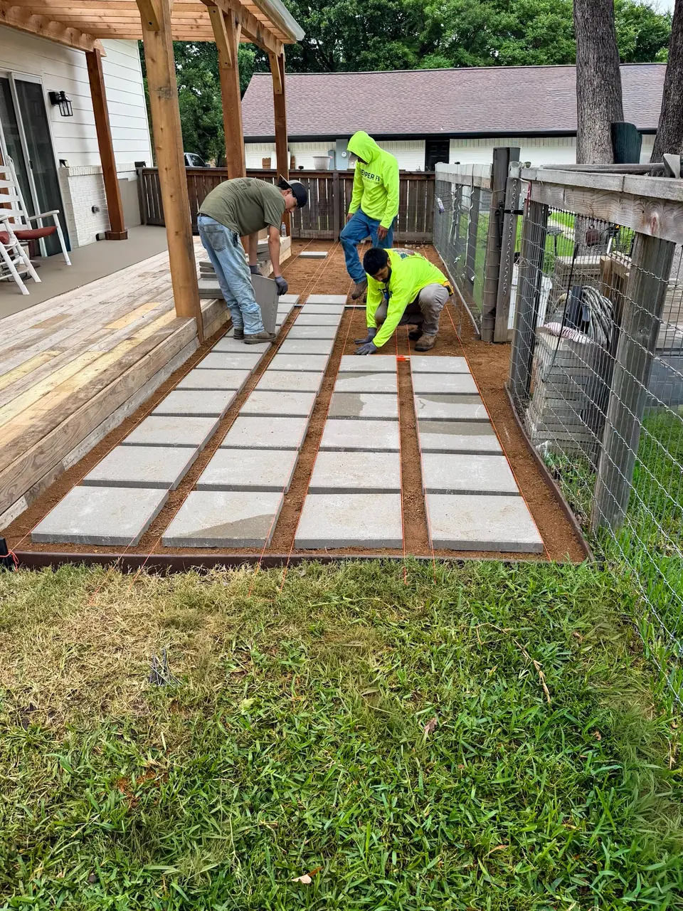 Semper Fi crew setting pavers for a patio on a Flower Mound, TX property